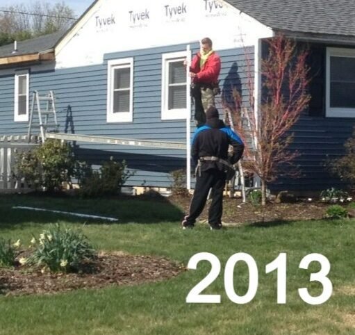 Siding installation in progress on a single-story home in Bucks County, PA, showing Tyvek house wrap and new vinyl siding being installed by The Little Siding Company (2013)