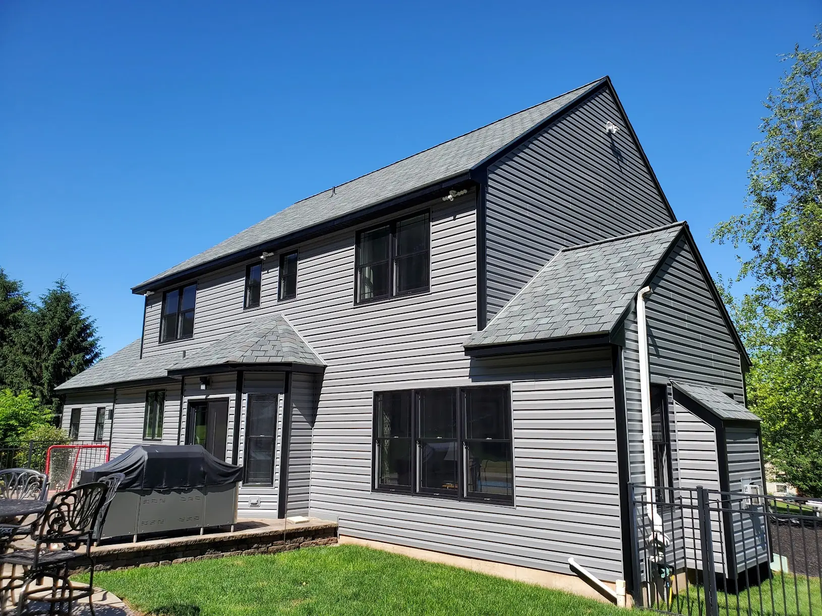 Exterior remodeling contractor in Newtown PA CertainTeed vinyl siding installation with black Andersen 400 windows Newtown PA