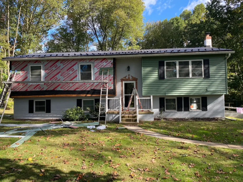 vinyl siding replacement with white trim and black shutters Morrisville PA